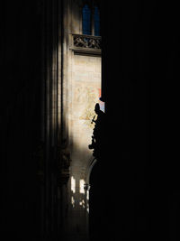 Silhouette building by window