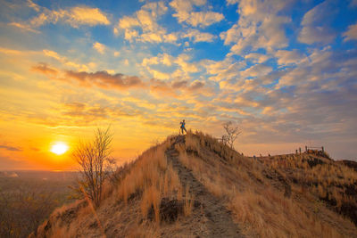 Scenic view of land against sky during sunset