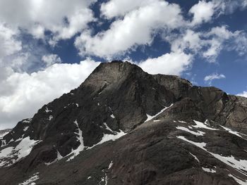 Low angle view of snowcapped mountains against sky