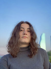 Portrait of a teenage girl against blue sky
