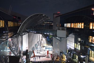 Illuminated city against sky at night