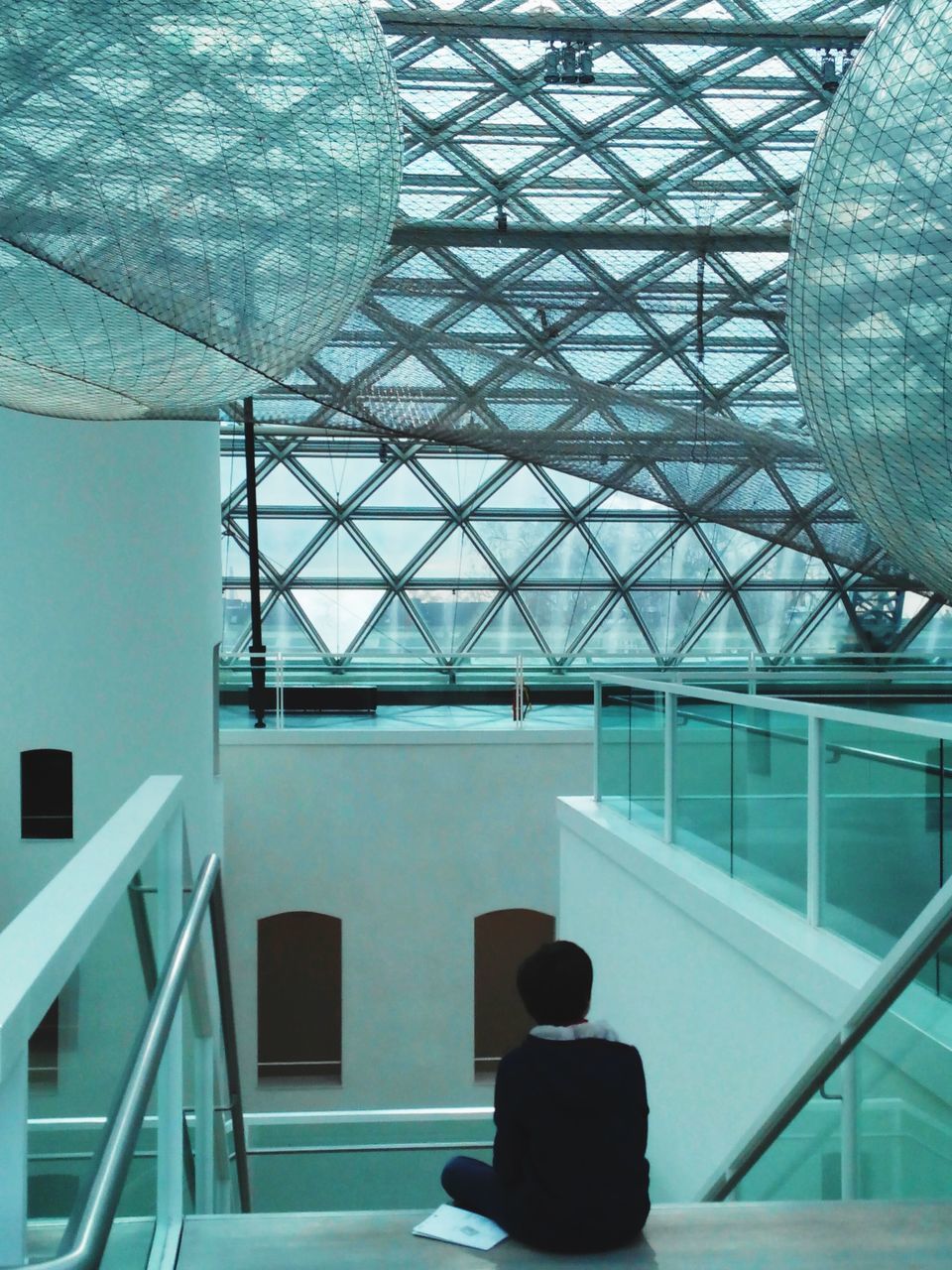 REAR VIEW OF PEOPLE ON GLASS WINDOW AT MUSEUM