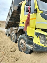 High angle view of yellow cart on sand