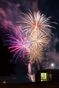 Low angle view of firework display at night