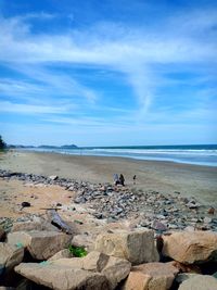 Scenic view of beach against blue sky