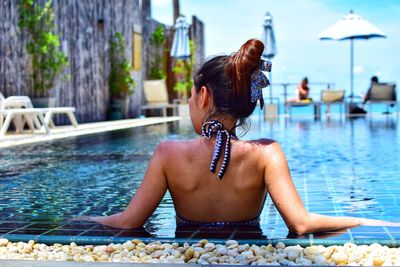 Rear view of woman in swimming pool