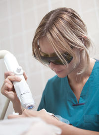 Close-up of woman getting beauty treatment from doctor