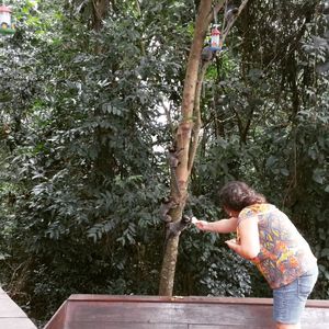 Boy standing on tree trunk