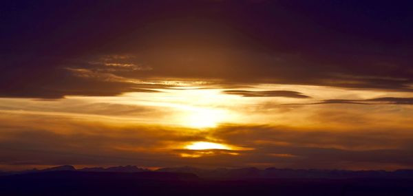 Scenic view of dramatic sky at sunset