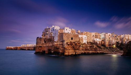 View of town by sea against sky