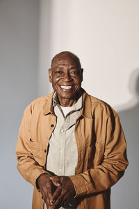 Portrait of elderly man over white background at studio