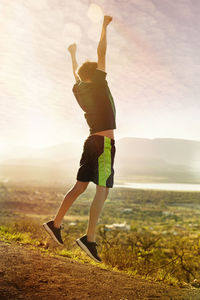 Full length of man jumping against sky