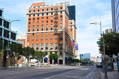 City street and buildings against sky