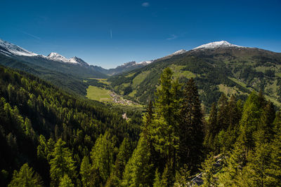 Scenic view of green mountains against sky