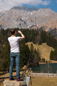 Rear view of man photographing