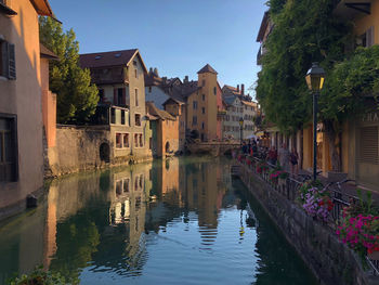 Canal amidst buildings against sky