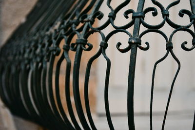 Close-up of metal chain hanging on fence