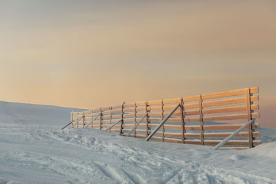 Fence in snowy winter landscape