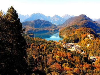 View of calm sea against rocky mountains