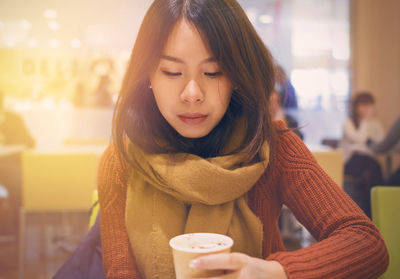 Portrait of young woman using mobile phone