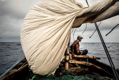 Night fishing. a man pulls out a fishing net at night. indian ocean