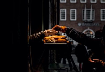 Man holding ice cream standing in city