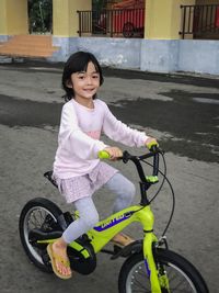 Portrait of cute girl riding bicycle