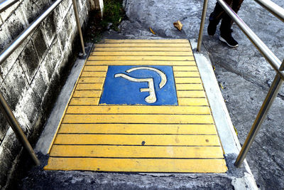 High angle view of arrow sign on staircase