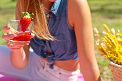 Midsection of woman holding ice cream