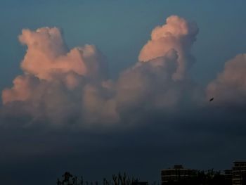 Low angle view of silhouette buildings against sky at sunset