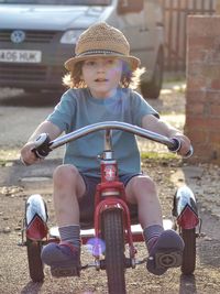 Full length of cute girl riding motorcycle