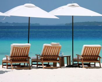 View of sun loungers at seaside