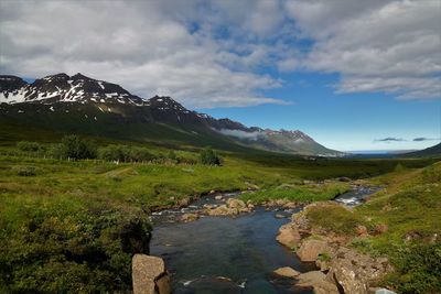 Scenic view of mountains against cloudy sky