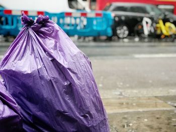 Close-up of wet garbage bag at sidewalk