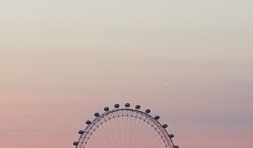 Low angle view of ferris wheel against sky