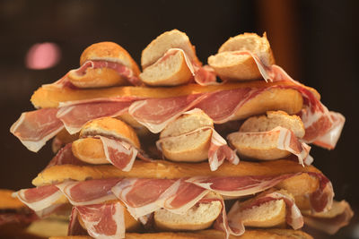 This image shows a stack of sandwiches. each sandwich looks to be made with a small baguette 
