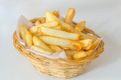 Close-up of burger and fries on white background