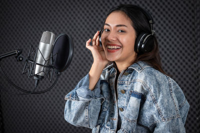 Portrait of a smiling young woman using mobile phone