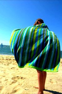 Rear view of man standing on beach