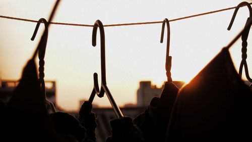 Close-up of silhouette people against clear sky during sunset