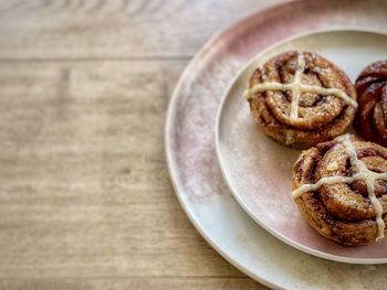 High angle view of hot cross buns in plate on table.