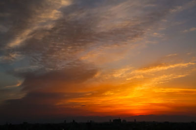 Silhouette buildings against sky during sunset