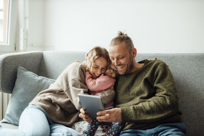 Happy family using tablet pc at home