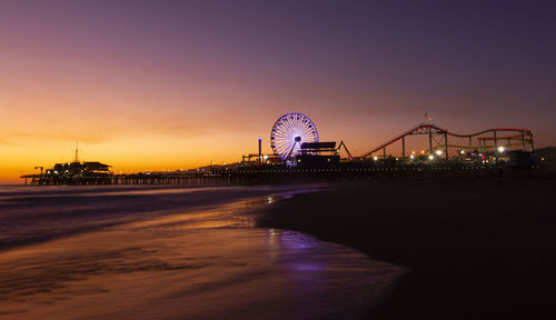 Illuminated ferris wheel at night