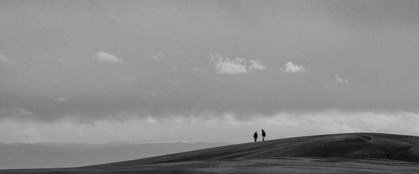 Scenic view of mountains against cloudy sky