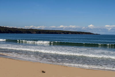 Scenic view of beach and sea against blue sky