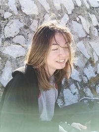 Close-up of smiling young woman outdoors