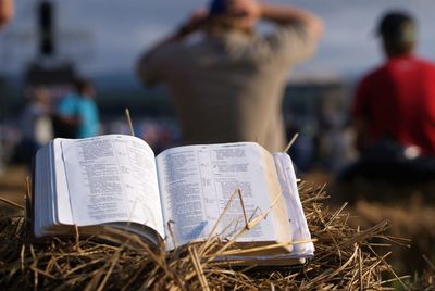 Close-up of open book on hay