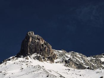 Low angle view of snowcapped mountain against sky