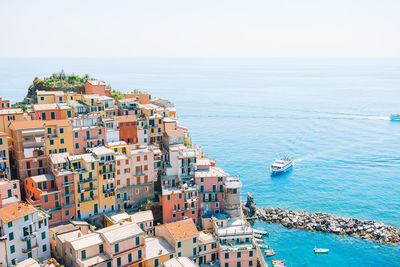 High angle view of townscape by sea against sky